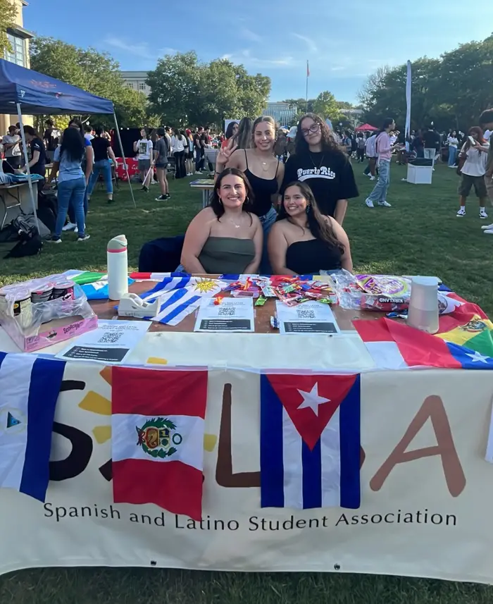 students at organization fair sitting at table