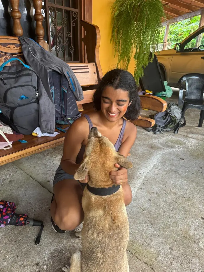 Sruti smiling with a dog