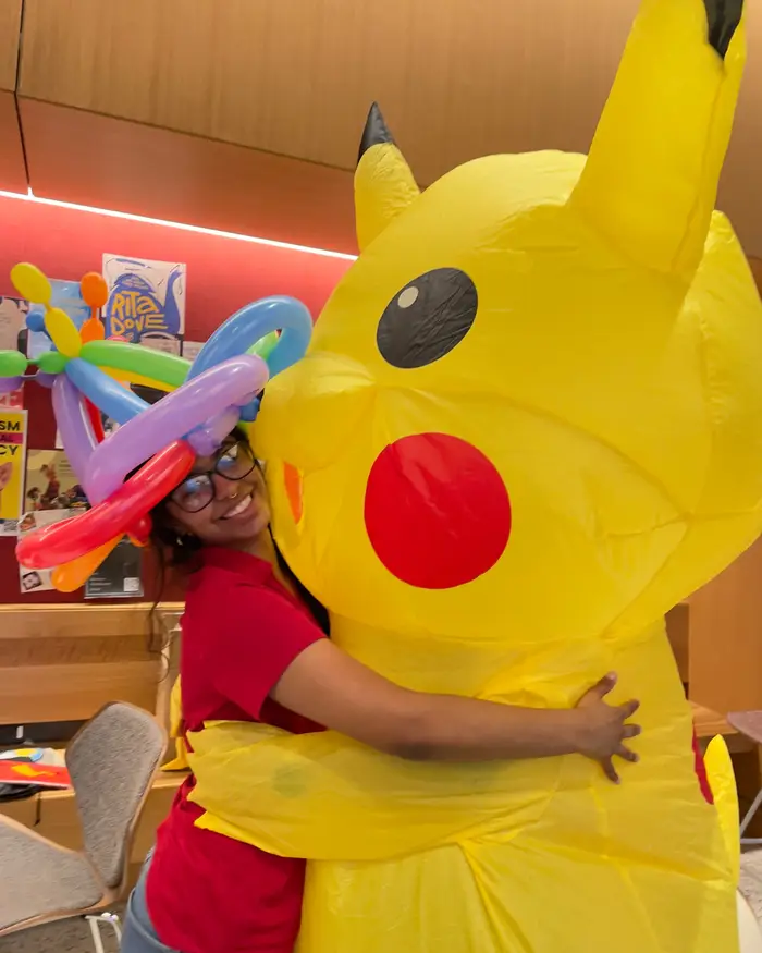 Evangeline hugs Pikachu during a visit in her residence hall