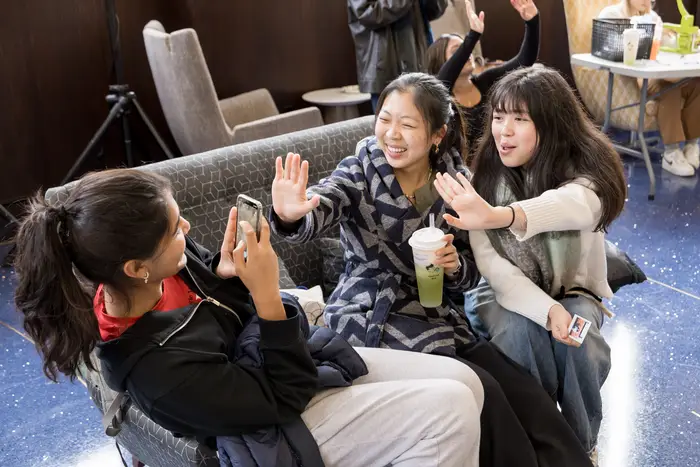 Students laugh while taking a photo during IS day