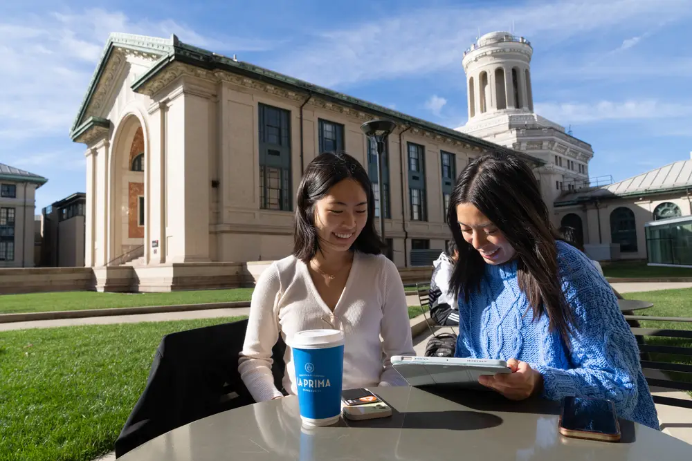Two students sitting on campus