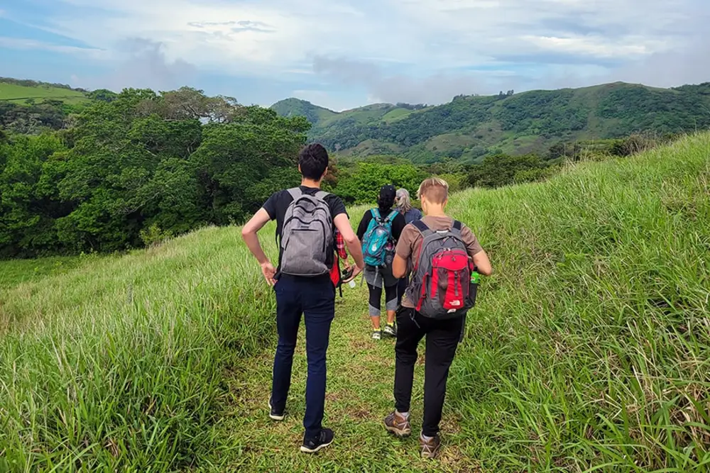 An image of a group backpacking through mountains.