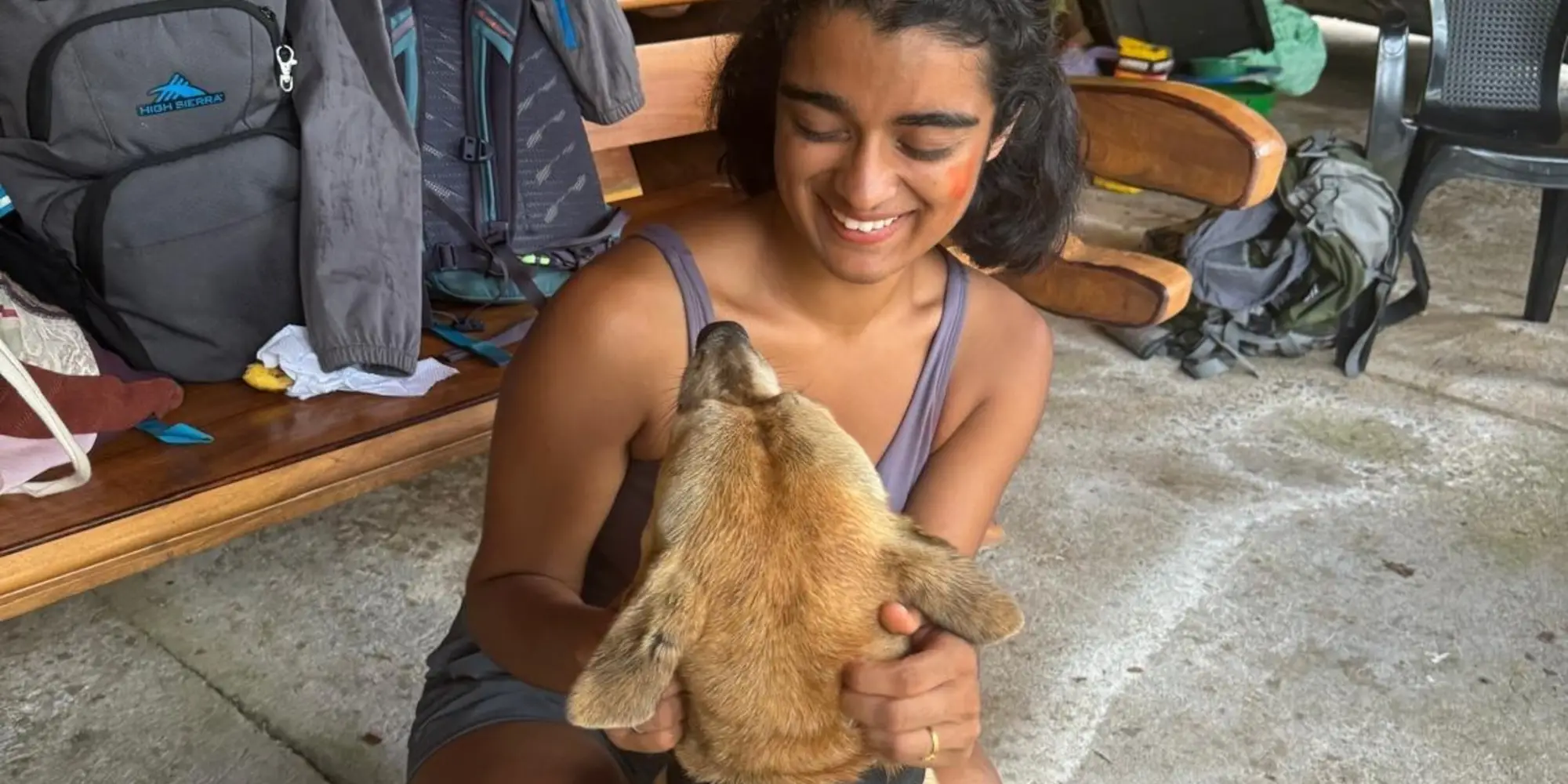 Sruti smiling with a dog