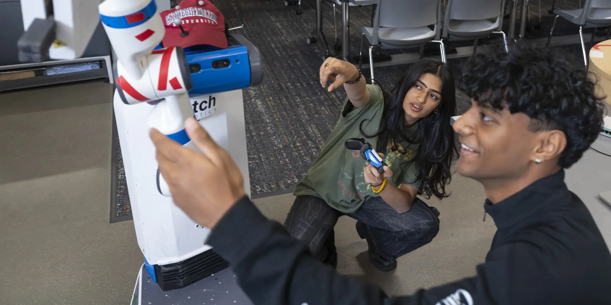 Two students working on a robot