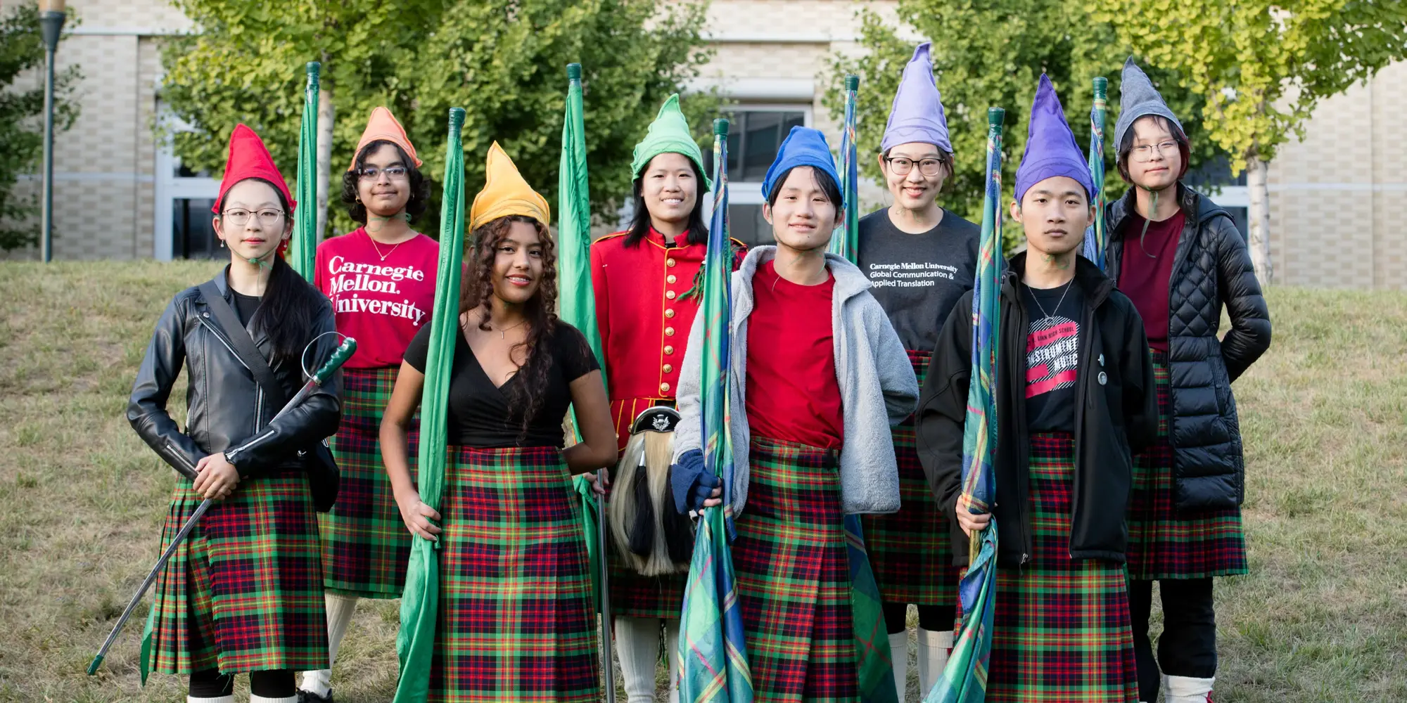 Cindy and their Kiltie Color Guard friends pose for a photo
