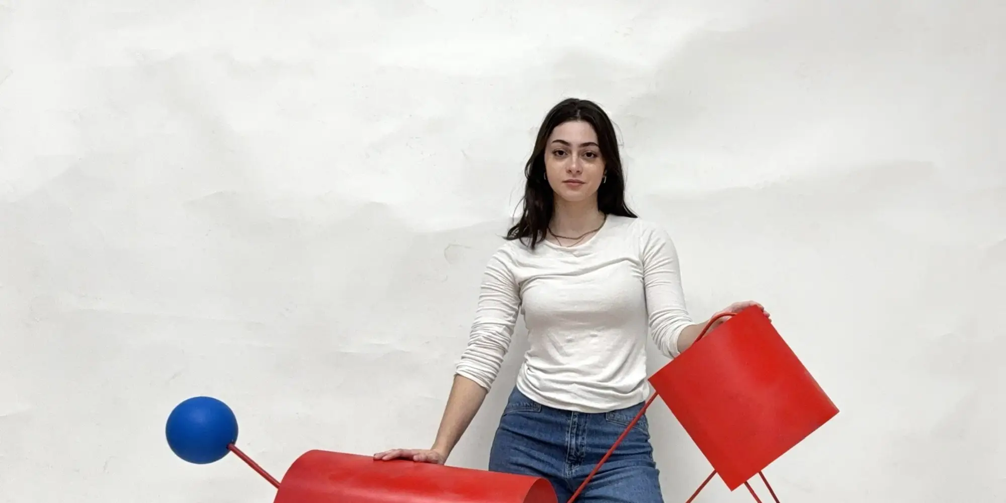 Orli posing with a sculpture project she created