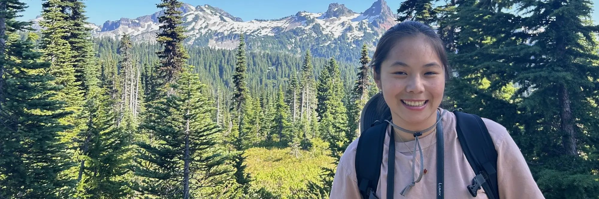 Student posing in front of mountains