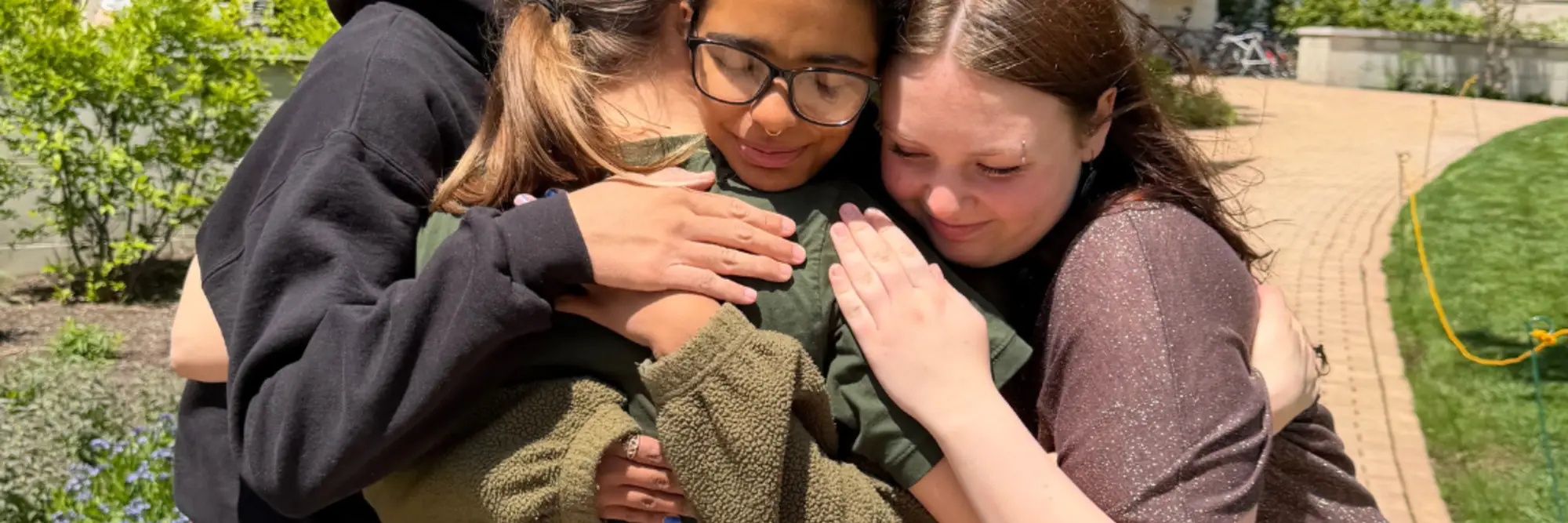 Evangeline and friends hug outside of their dorm during move-out