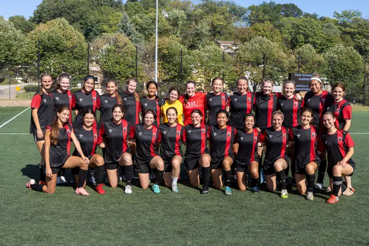 Lydia and club soccer team pose for a photo
