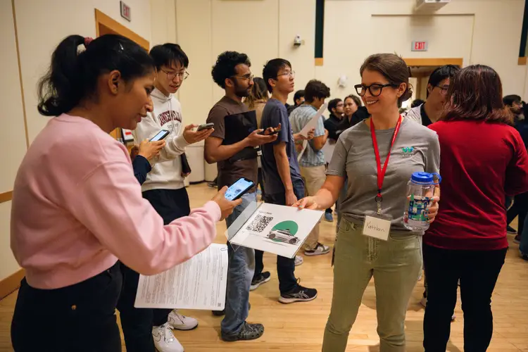 Students scan QR code at a career fair