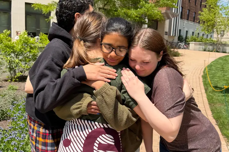 Evangeline and friends hug outside of their dorm during move-out