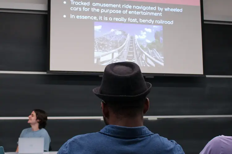 Photo of a presentation and audience member